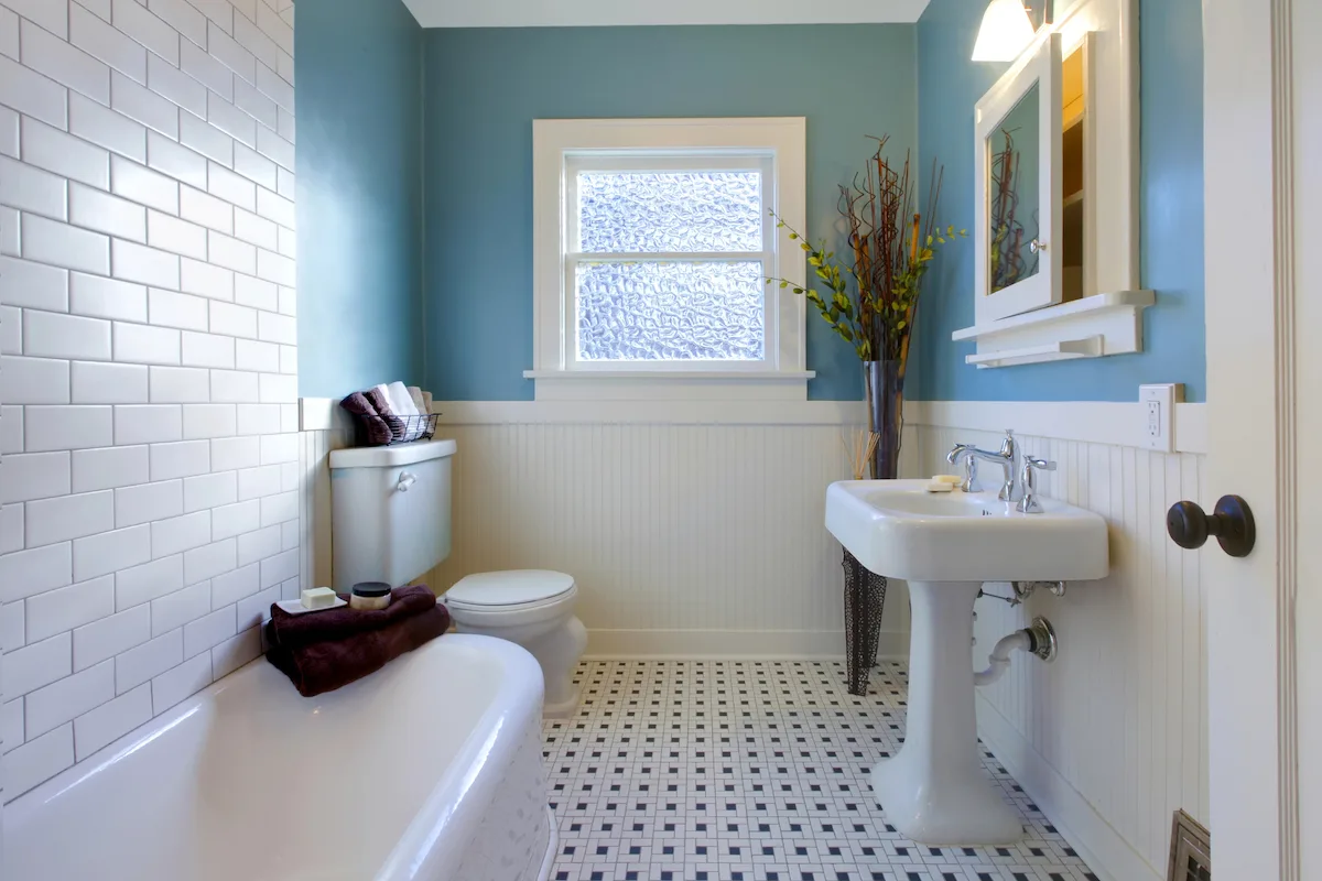 Character bathroom with a freestanding clawfoot-style bath and custom layout