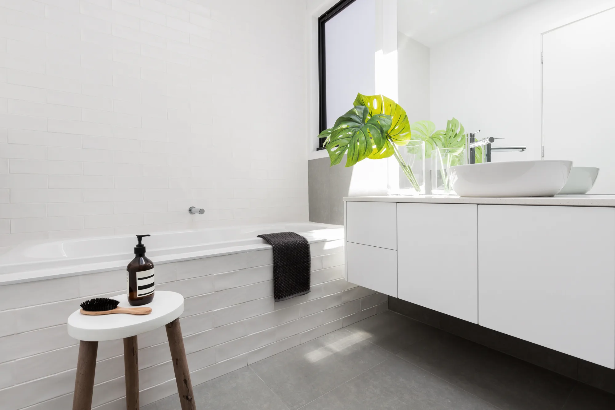 Bright, fully renovated bathroom with a floating vanity
