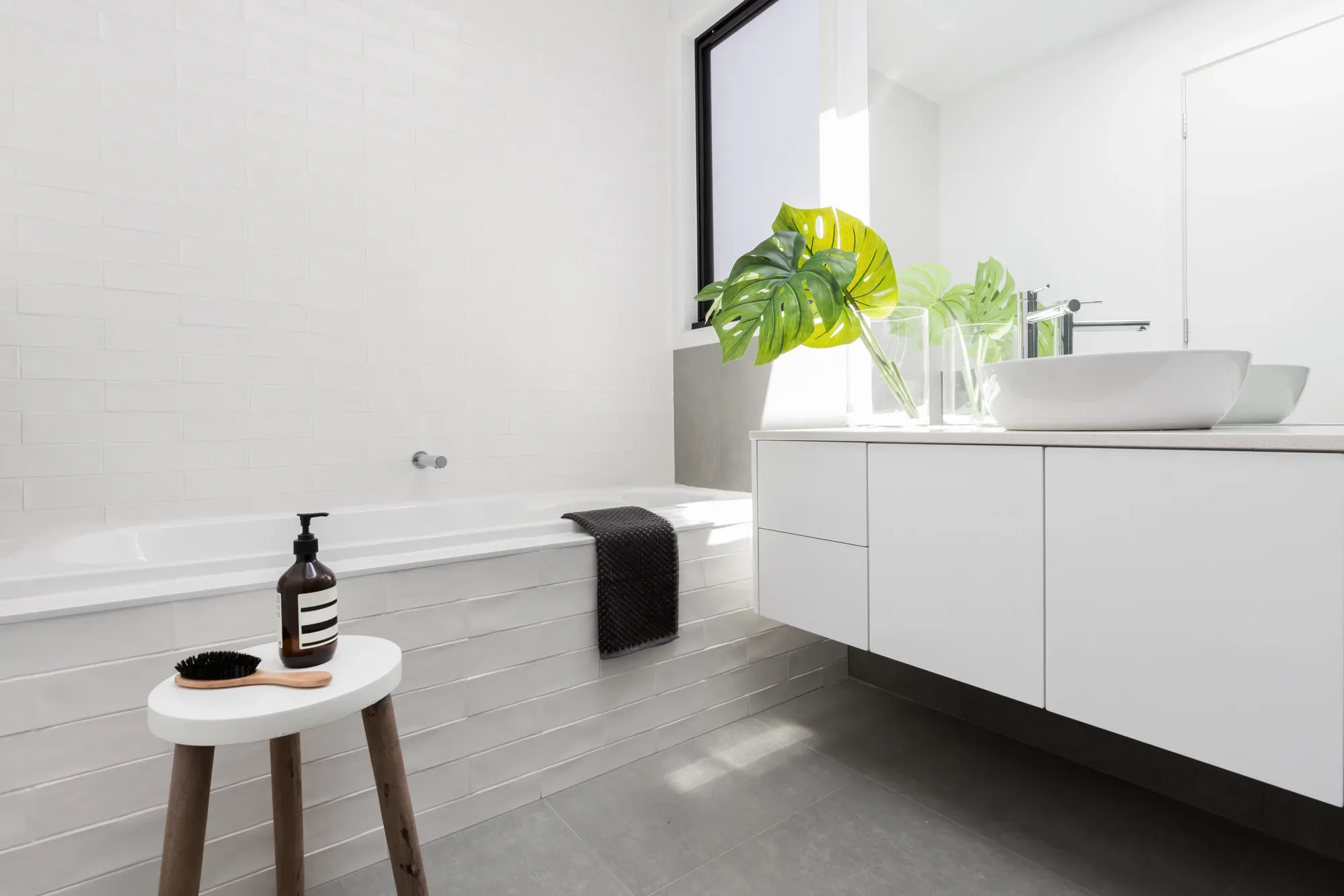 Bright, fully renovated bathroom with a floating vanity