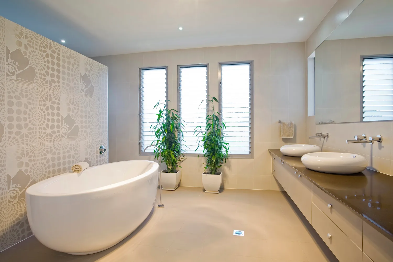 Luxury bathroom with a freestanding tub and feature tiled wall